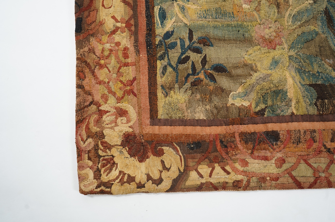 A mid to late 18th century French Aubusson tapestry of a bird, possibly a heron, within a tree lined verdure garden scene to a chateaux, with an ornate rust coloured contrasting tapestry border.201cm x 170 cm. Condition